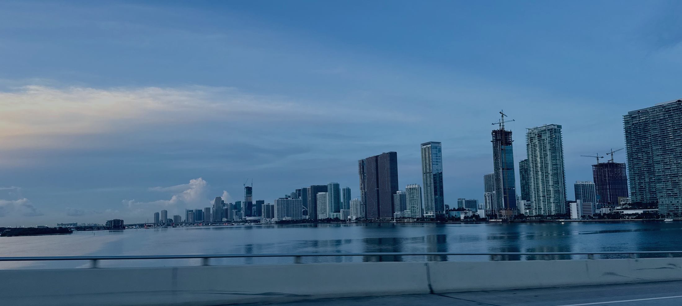 The Miami skyline across Biscayne Bay at dawn, photographed from the causeway